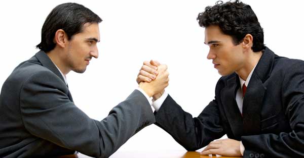 Businessmen arm wrestle to settle a dispute