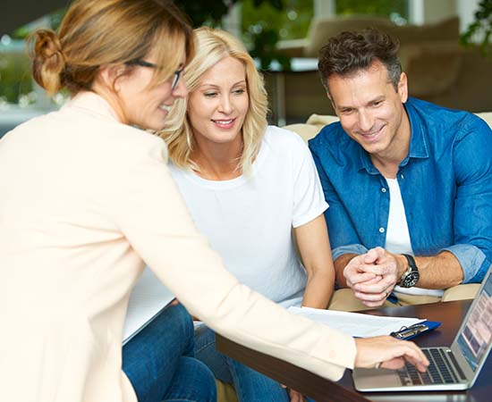 Shot of a middle aged couple consulting with their REALTOR