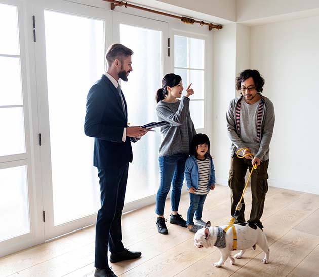 young family with a dog viewing a potential new home